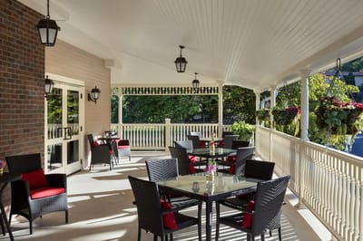 Outdoor patio area with seating and greenery