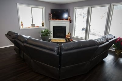 A cozy lounge area with a fireplace and large windows.