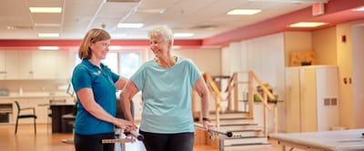Therapist assisting a resident in a bright activity room