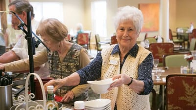 Residents enjoying meal service in the dining room