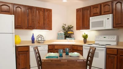 Cozy kitchen area with wooden cabinets and dining table