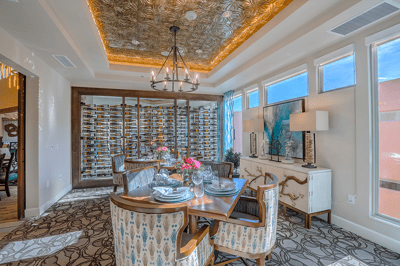 Elegant dining room with a decorative ceiling and wine storage