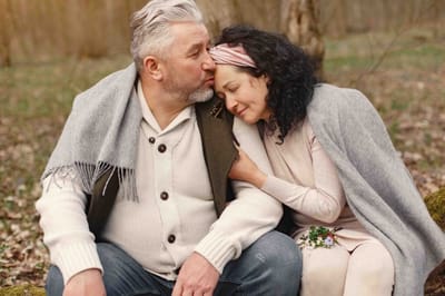 A couple sitting together in a peaceful outdoor setting