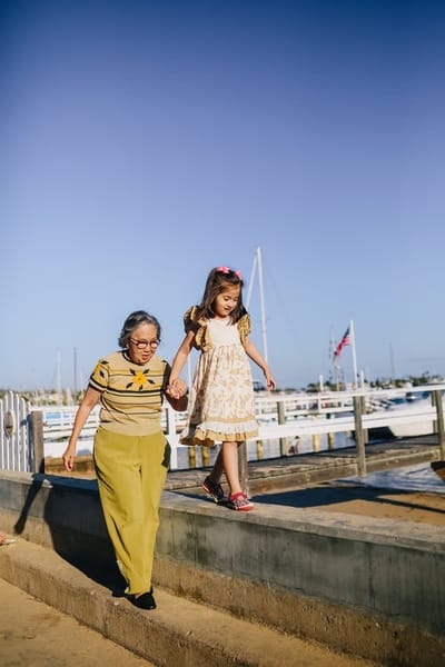 Senior and child walking by the waterfront