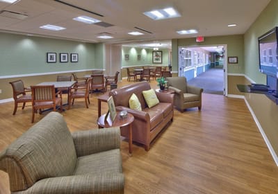 Common area with seating and tables in a senior living facility