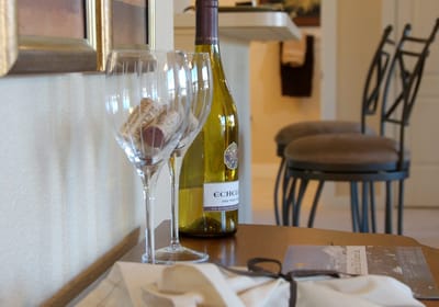 Close-up of wine glasses and a bottle in a cozy room