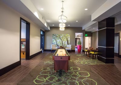 Interior view of a common area with a shuffleboard table