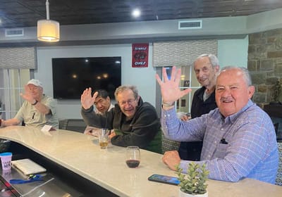 Residents socializing and enjoying drinks at a bar area