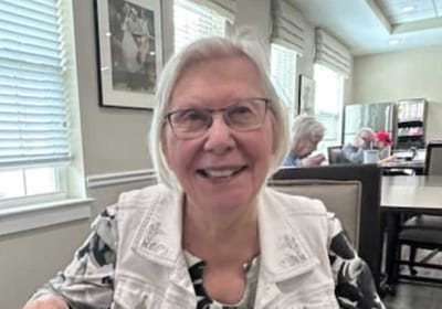 Resident smiling in a common area setting