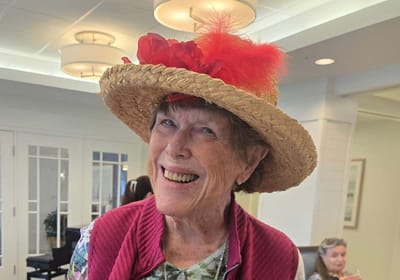 Resident wearing a festive hat in a common area