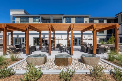 Outdoor seating area with pergola and stone features
