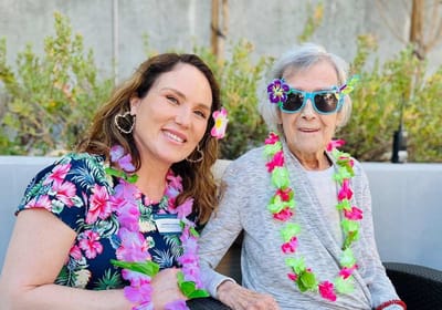 Resident and staff member enjoying a themed event outdoors