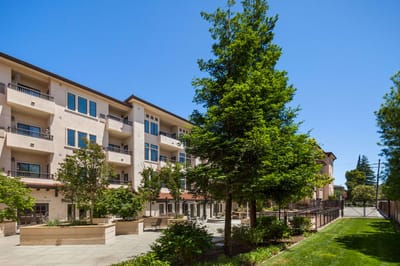 Exterior view of a senior living facility with landscaping.