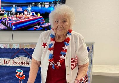 Resident celebrating at a festive event with decorations
