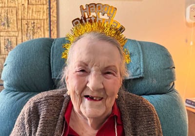 Resident celebrating birthday in a cozy chair