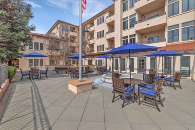 Outdoor patio area with tables and umbrellas