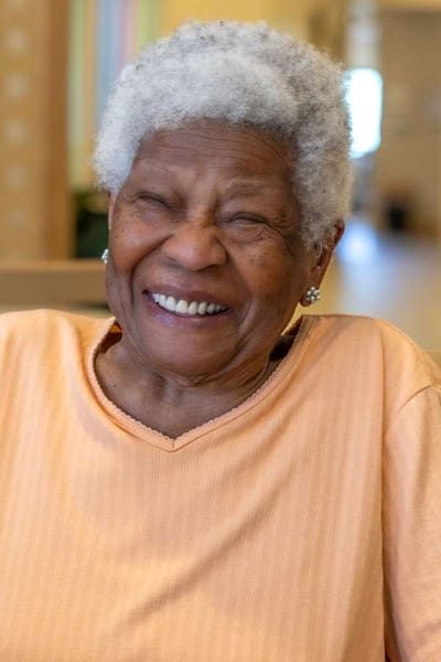 Smiling resident in a cheerful indoor setting