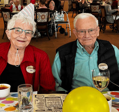 Residents celebrating with party hats and food