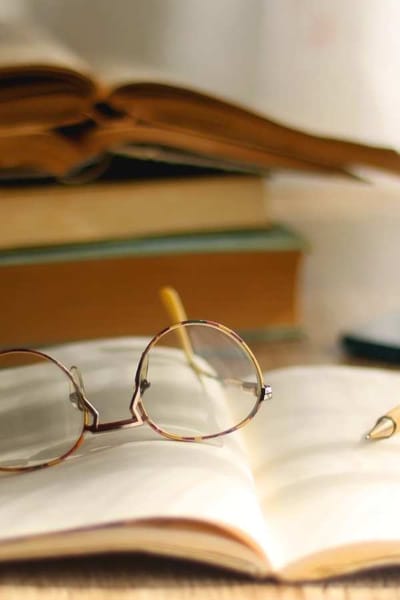 A pair of reading glasses on an open book