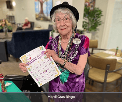Resident enjoying Mardi Gras bingo activity