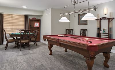 Interior game room with a billiards table and seating