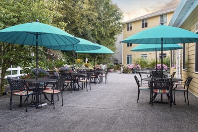 Outdoor patio area with tables and umbrellas
