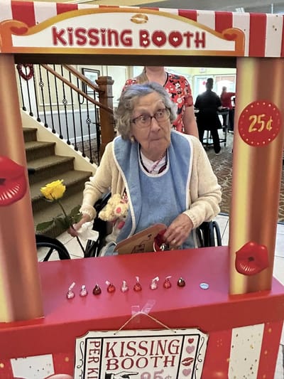Resident enjoying a kissing booth activity