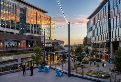 Outdoor shopping area with people during sunset