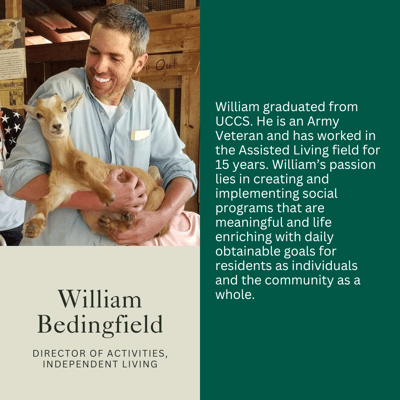Director of Activities holding a young goat