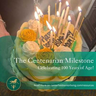 A birthday cake with candles celebrating a centenarian