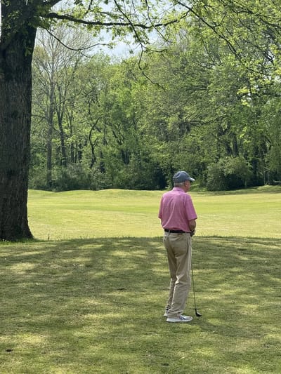 A resident enjoying a game of golf outdoors