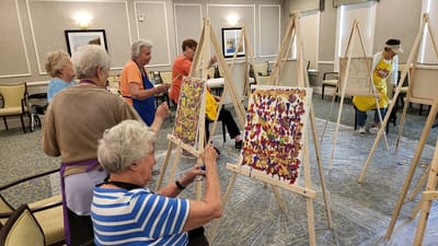 Residents engaged in an art activity in a common area