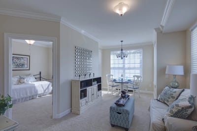 Interior of a resident room with a bed and dining area