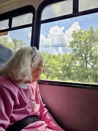 Senior woman looking out a bus window