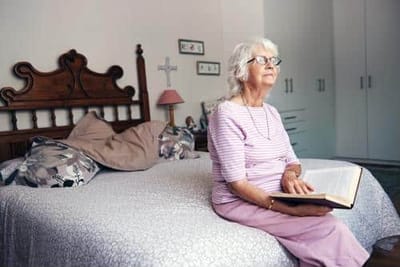 A resident reading in a cozy bedroom