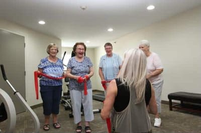 Residents engaged in a group exercise activity indoors