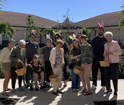 Residents and staff with Easter baskets outdoors