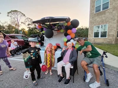 Residents and staff in costumes at a Halloween event