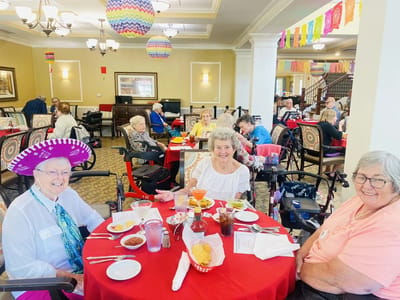 Residents enjoying a festive meal in the dining room
