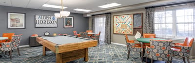 Bright common area with seating and a pool table
