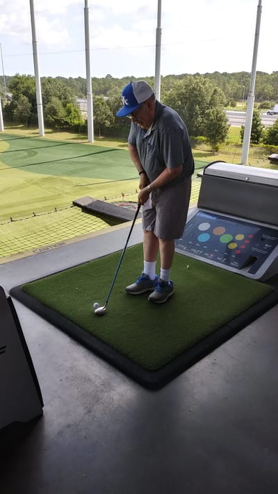 Resident practicing golf swing at the facility