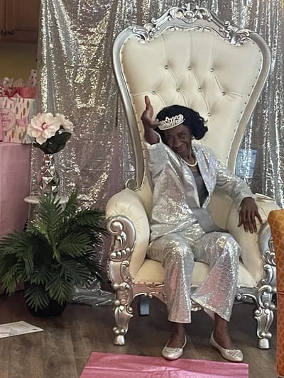 Resident celebrating in a sparkling outfit in a festive interior