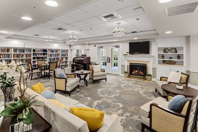 Bright and airy common area with bookshelves and seating