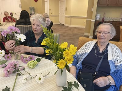 Residents arranging flowers in a common area