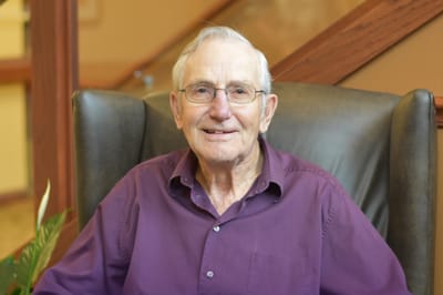 Resident smiling in an indoor setting