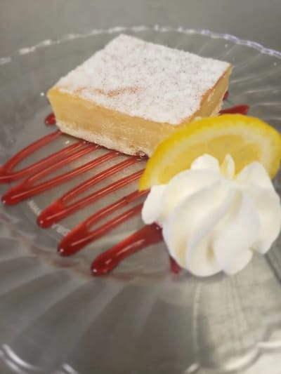 Dessert plate with lemon bar and whipped cream