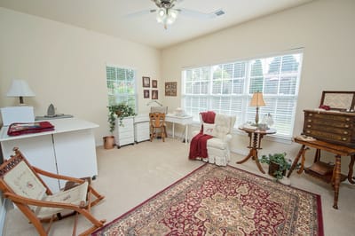 Cozy resident room with light-colored walls and seating area