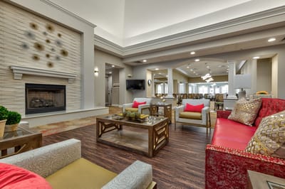 Bright and inviting common area with seating and fireplace