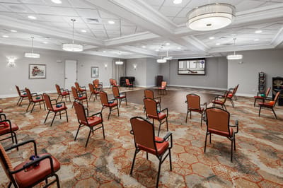 Interior activity room with spaced seating arrangements