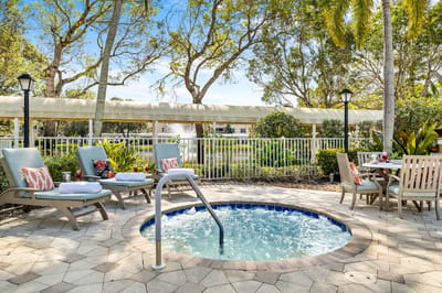 Outdoor spa area with lounge chairs and tables
